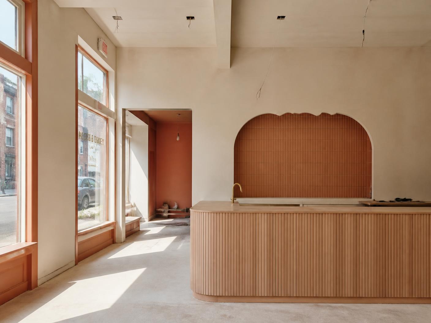 The empty Nouna’s storefront mid-renovation, with cream walls and a terracotta counter